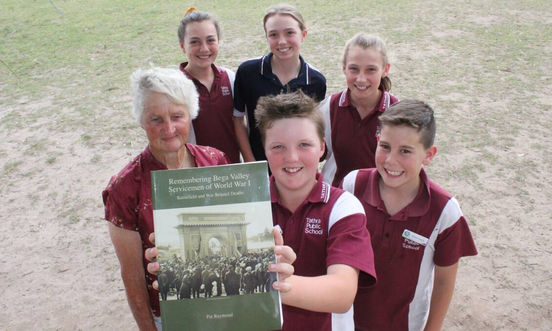 HISTORY BUFFS: Tathra Public School's Jack McMahon holds a copy of the book presented by Bev Koellner, surrounded by his classmates Taleah Clifton, Lily Hayden, Maddison Morehead and Liam Chandler. 