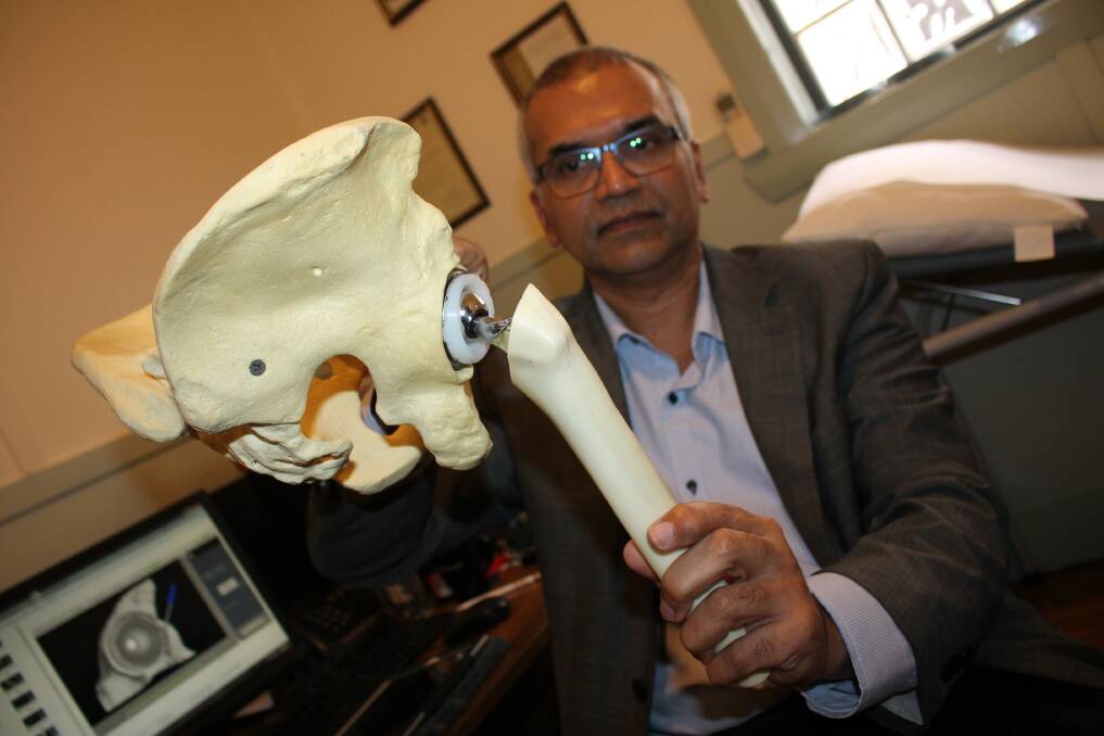 DELICATE PROCEDURE: Dr Krishnankutty Rajesh holds a model used to show what a hip replacement looks like. 