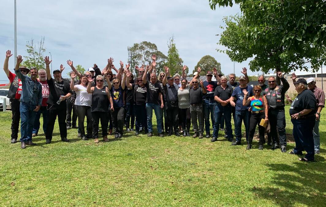 BIG HEARTS: Motorcyclists who joined the toy run on Saturday celebrate collecting over 70 presents after they arrived in Littleton Gardens, Bega. 