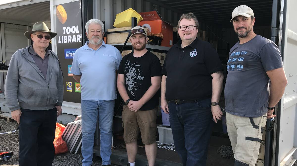 Standing in front of a container of donated tools are masons Malcolm Privett, Glen Green, Joshua Shoobridge and David Porter with the Triangle Tool Library's Scott Herring.