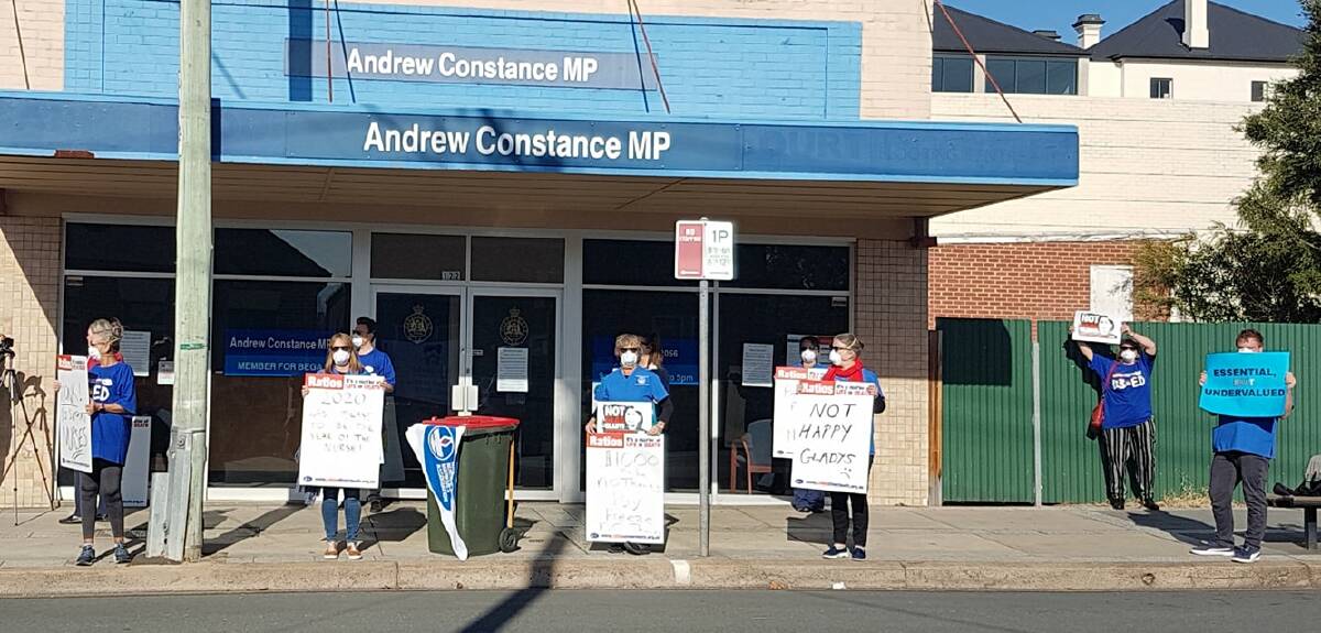 The local branch of the NSW Nurses and Midwives' Association protest outside Bega MP Andrew Constances office in Bega in June. 