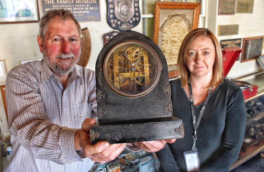 OLD TIMES: Peter Lacey and town planner Carley McGregor show off an old clock from the Bega Pioneers' Museum that came from Jellat Jellat.