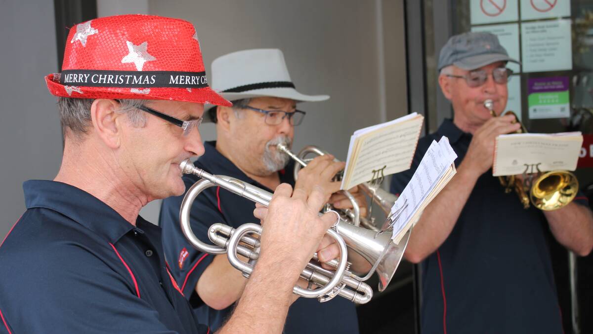 BRINGING IN CHRISTMAS: Members of the Bega District Band perform on the streets of Bega on Tuesday morning. 