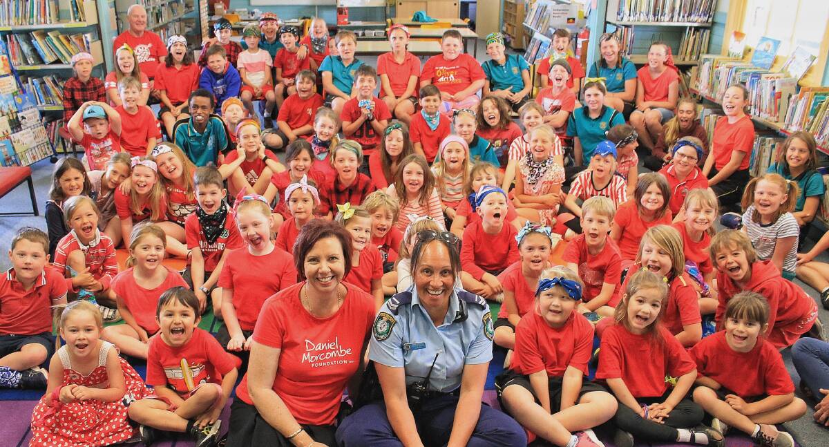 Day For Daniel ambassador Melissa Pouliot and Senior Constable Donna-Marie Clarke shout "safe" with children of Wolumla Public School. 