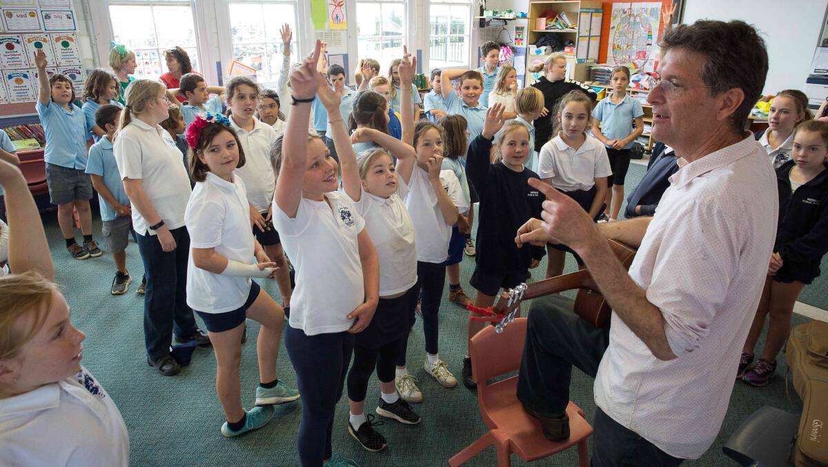 Geoffrey Badger teaches children at Bermagui Public School singing in preparation for the Youth Music Festival's Friday showcase. Picture: Chris Sheedy