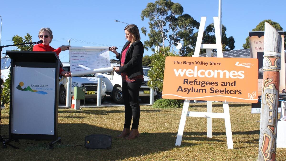 Rural Australians for Refugees' Jan Govett presents a welcome scroll with BVSC Mayor Kristy McBain in 2017.