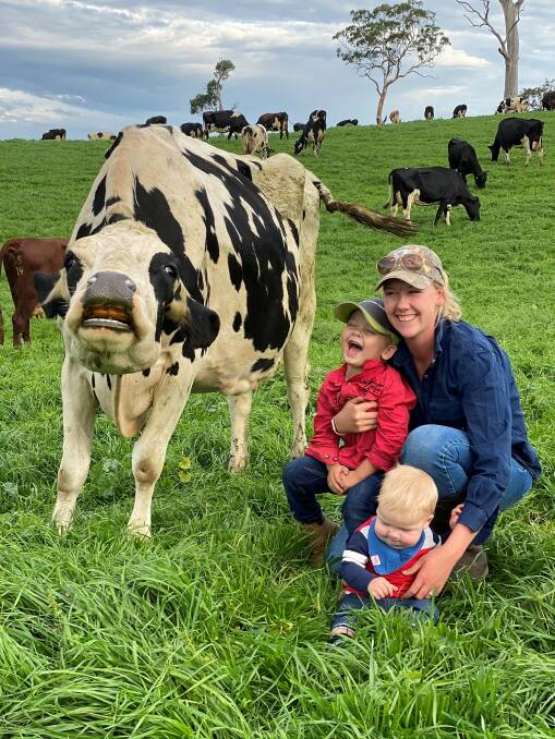 Brodie Game and her children Roy and Harry Game have fun getting close to one of the cows. Picture: Supplied 