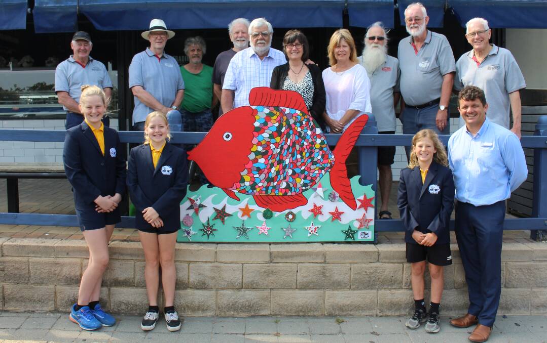EYE-CATCHING: Members of the Bermagui Chamber of Commerce, Men's Shed and Public School visit the signs installed on the town's main street.