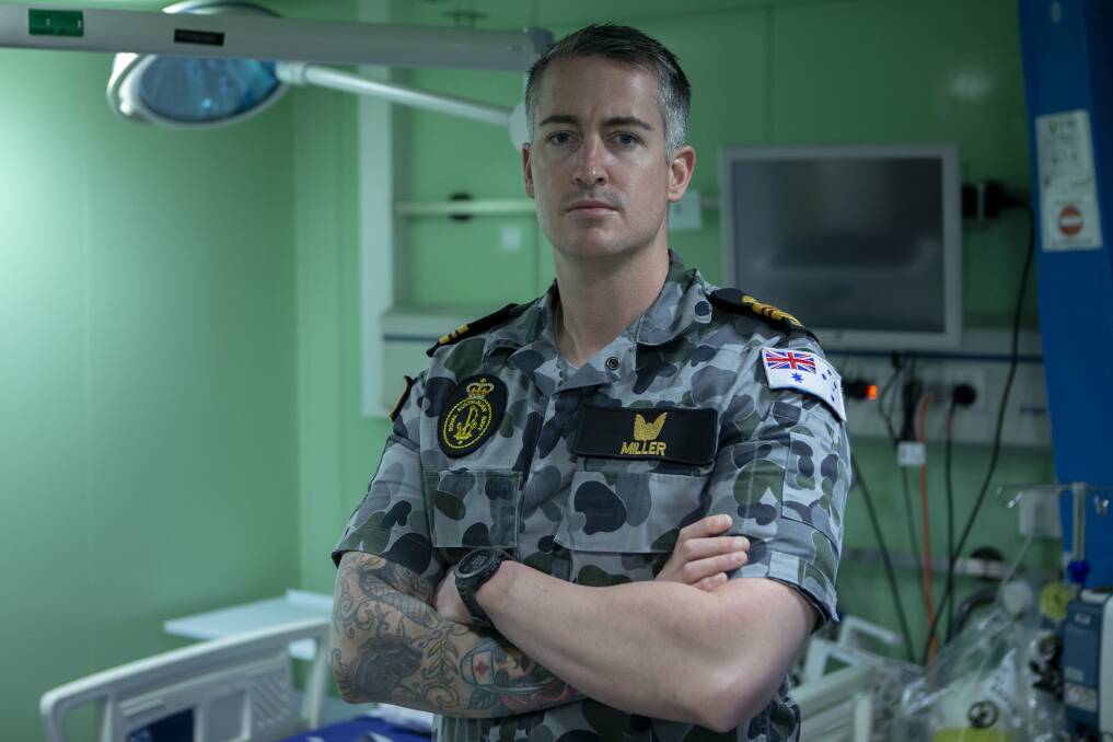 HMAS Adelaide's embarked senior nursing officer, Lieutenant Commander Thomas Miller, RAN, in the treatment room during Operation Bushfire Assist 19-20. Picture: ABIS Thomas Sawtell 