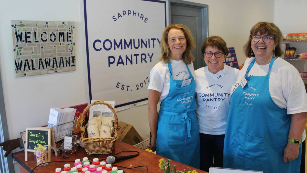 COMMUNITY SPIRIT: Christine Welsh (right), pictured with Sapphire Community Pantry volunteers Jo Oastler and Sue MacKinnon in 2018, is a finalist in prestigious awards. 