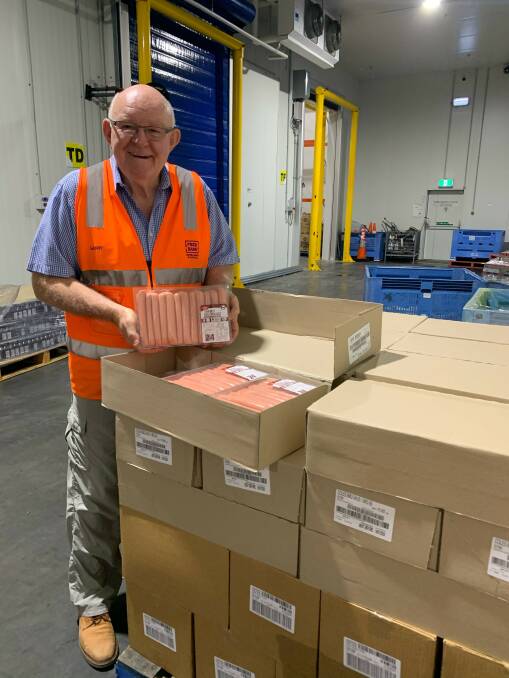Foodbank CEO Gerry Anderson with donated meat from Coles. 