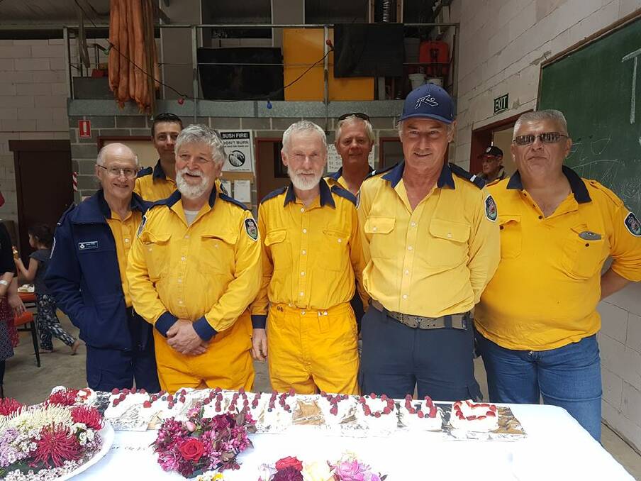 DEDICATED: Brogo Rural Fire Service's volunteers gather at the Brogo Fire Shed on Sunday where they are thanked by the community. 