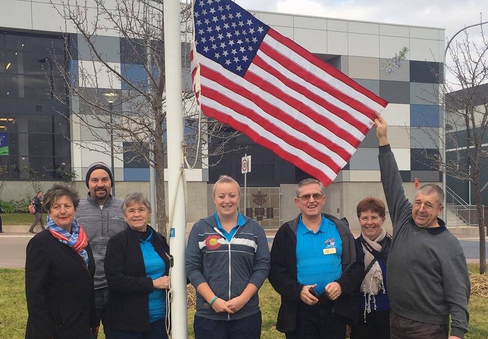 CONNECTING ACROSS THE WORLD: Members of the Bega-Littleton Sister City Exchange Group raise the USA's flag in Bega on Thursday. 