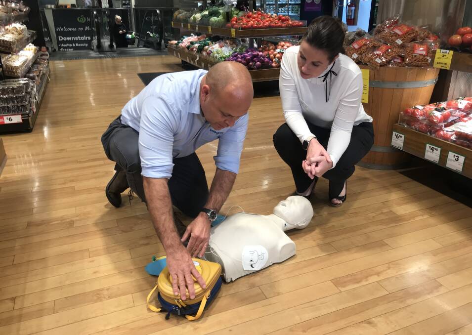 AIMING TO SAVE LIVES: Woolworths MD Claire Peters and Integrity Health CEO Liam Harte demo an AED unit in a Woolworths store. 