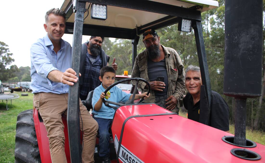 ALL ABOARD: Andrew Constance checks out the tractor with Merrimans Local Aboriginal Land Council board members Gary and Paul Campbell and CEO Terry Hill while Freddy Campbell sits behind the wheel. 