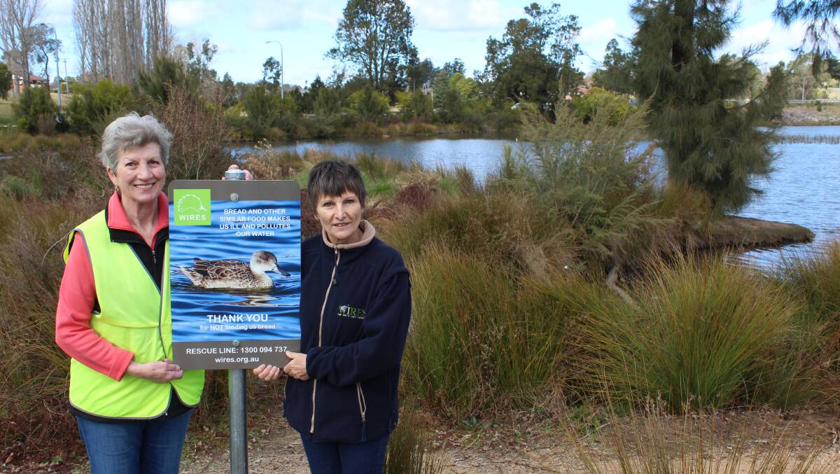 Margaret Shaw and Kerry McKenzie with one of the new signs at Kisses Lagoon. The sign was sponsored by Bendigo Bank. 