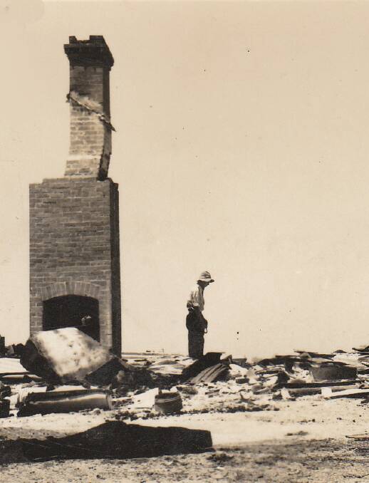 DEVASTATED: A farmer surveys the ruins of his property after the 1952 bushfire in the Bega Valley. Five people died during the blaze. 