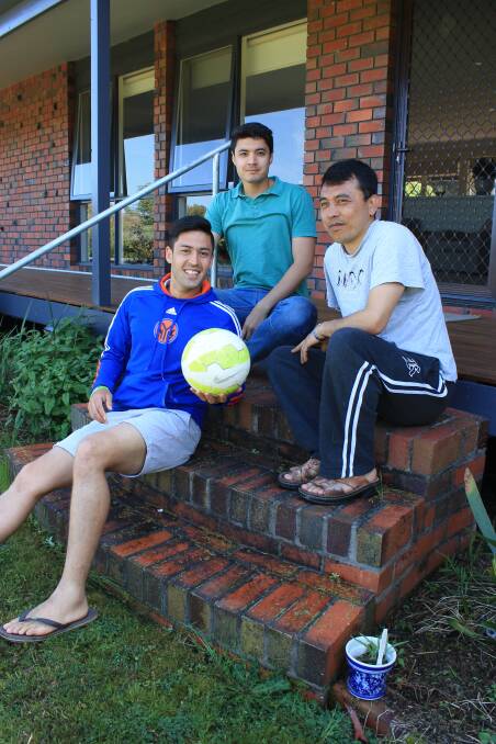 Soccer fans: Refugees Ahmad, Mahdi and Reza Poya take a break from playing soccer while they visit Kalaru in 2015. Photo: Albert McKnight