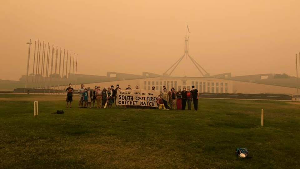 VALLEY NEEDS MORE: Bega Valley residents gather on the lawn of Parliament House on Sunday to call on the federal government to send more resources to the South Coast bushfires. Picture: Supplied 
