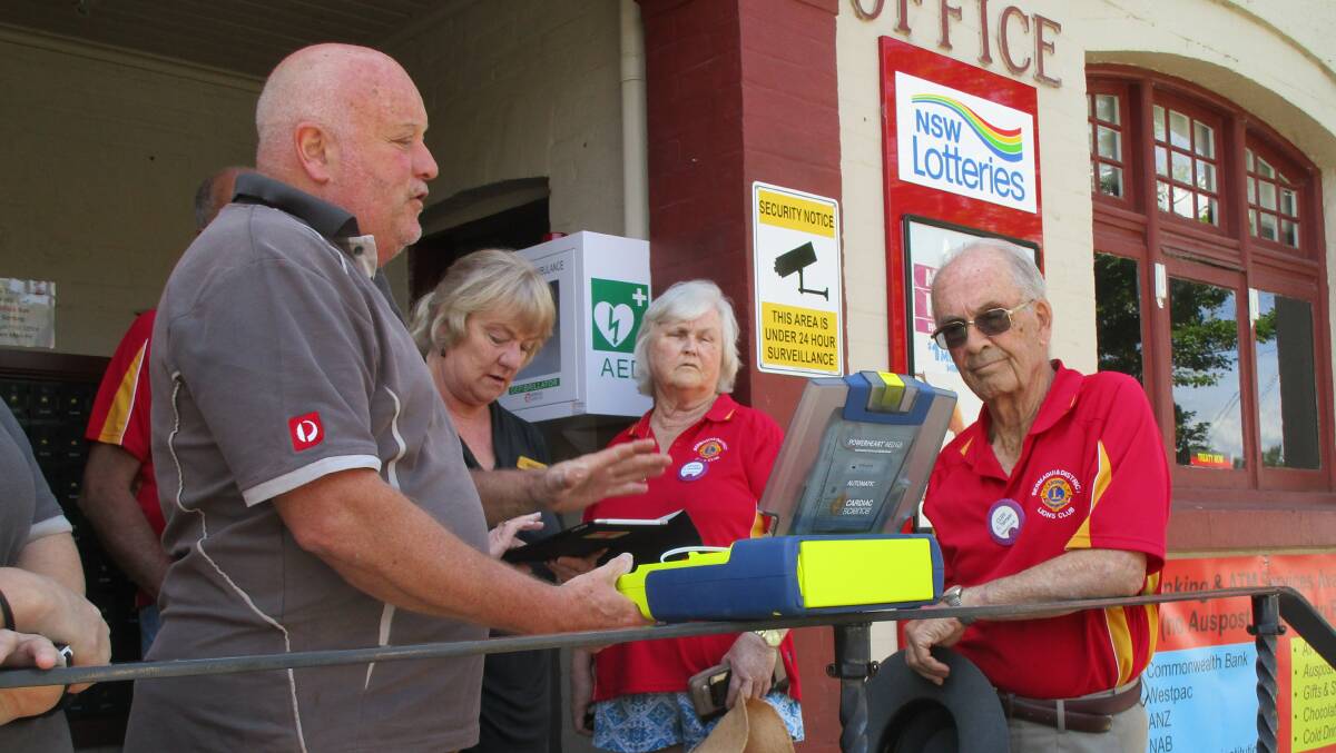 David Wilson from Cobargo Post Office, Natelie from Horizon Credit Union Bermagui, Susan Geerdink and Cliff Tarrant discuss the defibrillator on Friday. 
