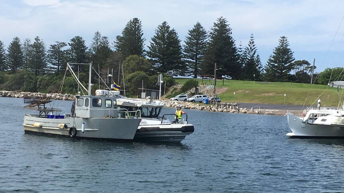 HERE TO HELP: Marine Rescue Narooma's NA30 guides the rescued boat into Bermagui's harbour. on Wednesday afternoon. Picture: Supplied 