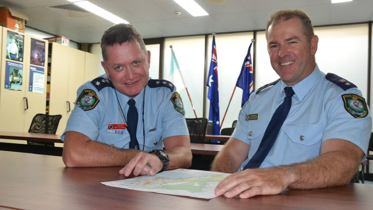 Nowra Inspector Ray Stynes and South Coast Police District Commander Superintendent Stephen Hegarty look over a map of the the South Coast region.