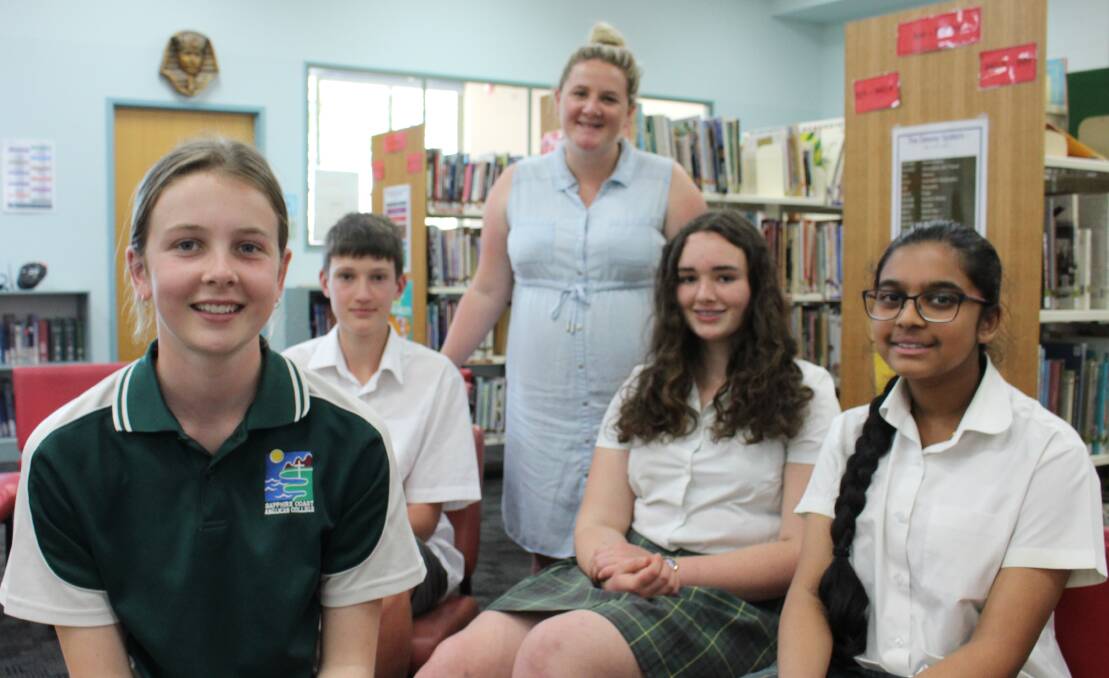 BRIGHT MINDS: Sapphire Coast Anglican College Year 8 students Amy De Friskbom, Aidan Clark, Grace Burns and Preethi Benjamin are congratulated by their teacher Casey Hoynes for enterting in the Young Scientist Competition. 