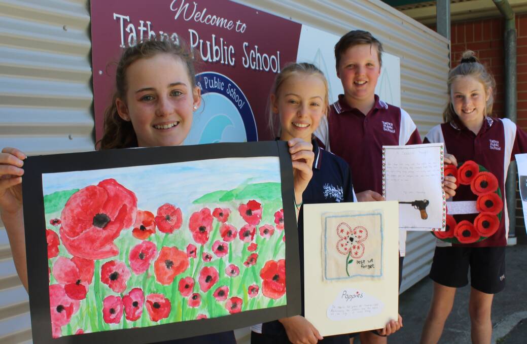 HISTORY BUFFS: Tathra Public pupils Kirra Turner, Sophie Moran, Jack McMahon and Issy Barker hold the projects they made to commemorate the end of WW1. 