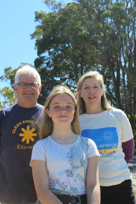 Clean Energy For Eternity president Matthew Nott, 13-year-old Tanja resident Anna Browne and 350.org CEO Blair Palese at the human sign in Tathra on Sunday. 