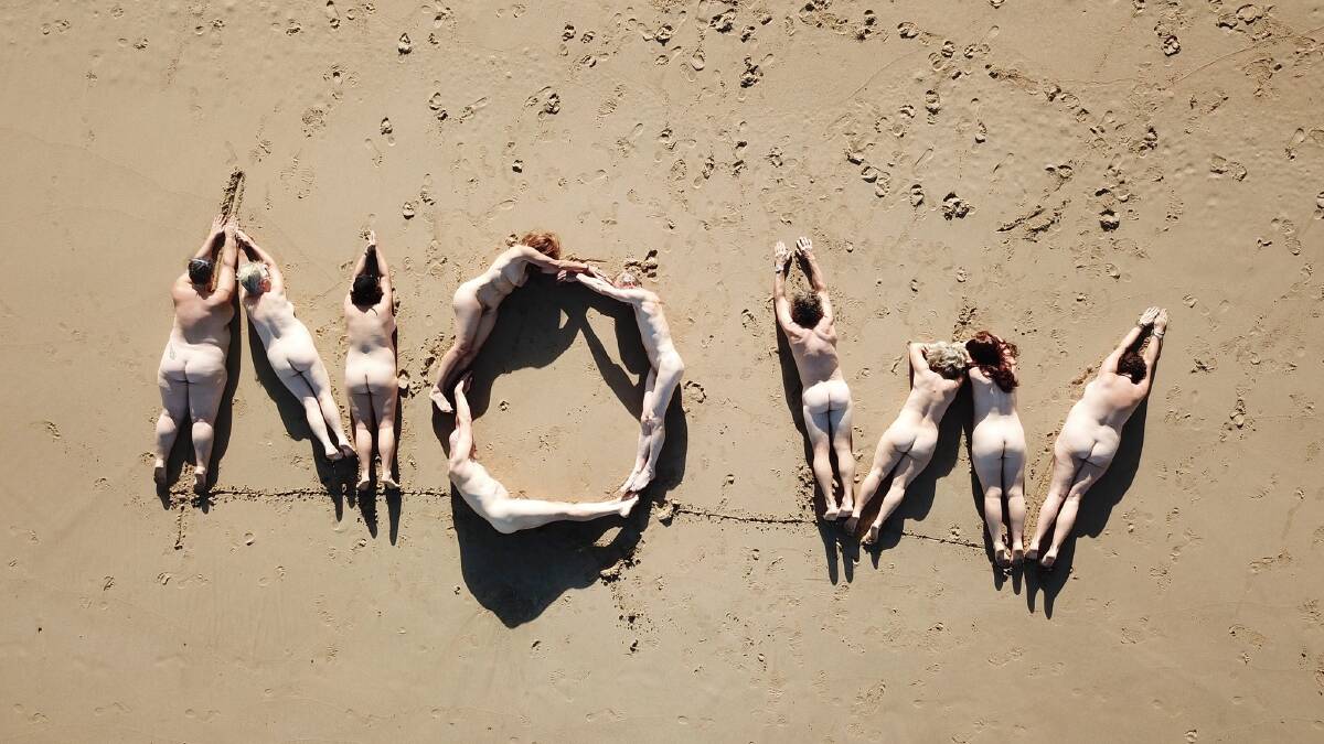 Activists form a nude sign at Moon Bay calling for action on climate change. Picture: Supplied 