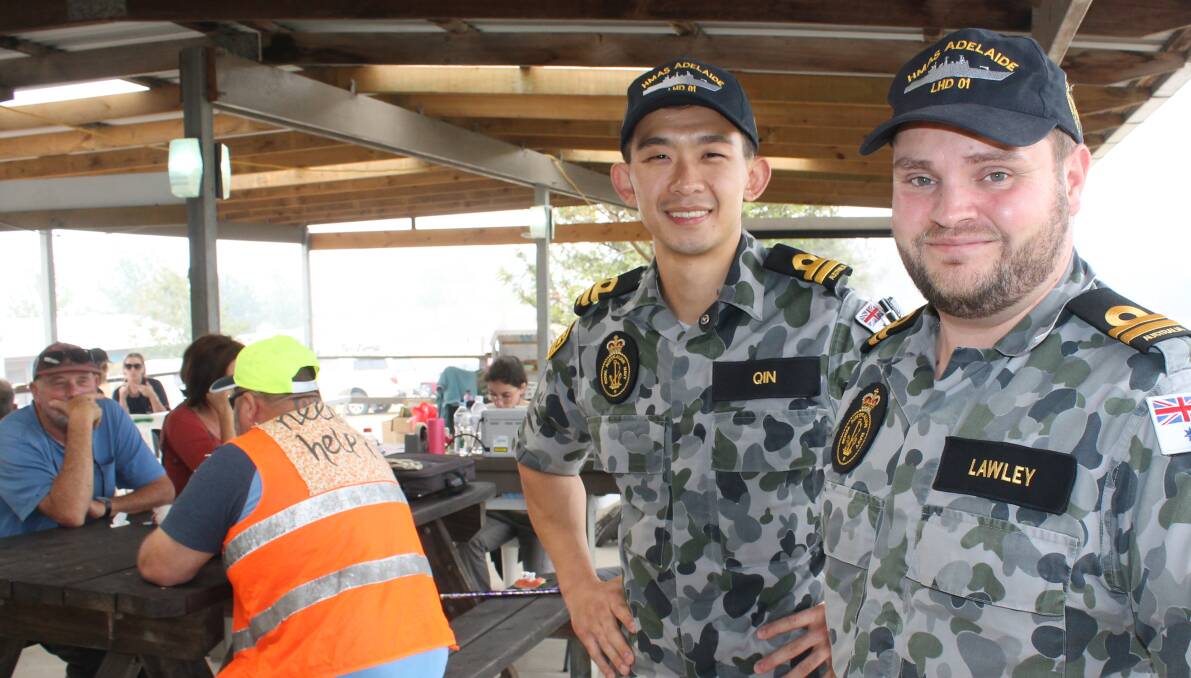 OFFERING SUPPORT: HMAS Adelaide Lieutenant Phillip Qin and engineer Mark Lawley visit the Cobargo Showground to learn of the scale of the bushfire disaster. 