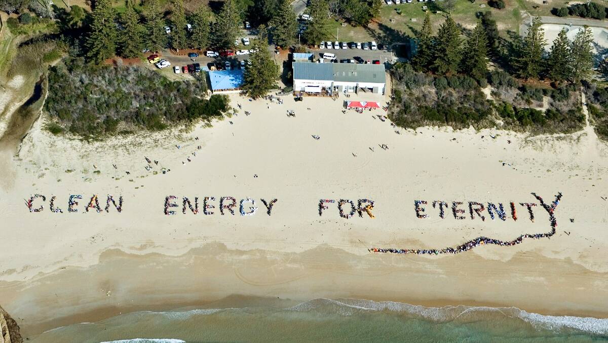 COMMUNITY SPIRIT: The Clean Energy For Eternity human sign was formed at Tathra Beach in 2006. There are hopes to form an even larger sign this month. 