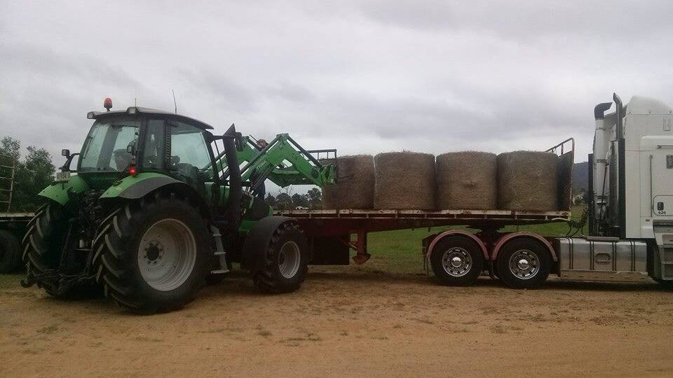 Hay bales are loaded onto a truck. Picture: Stock image 