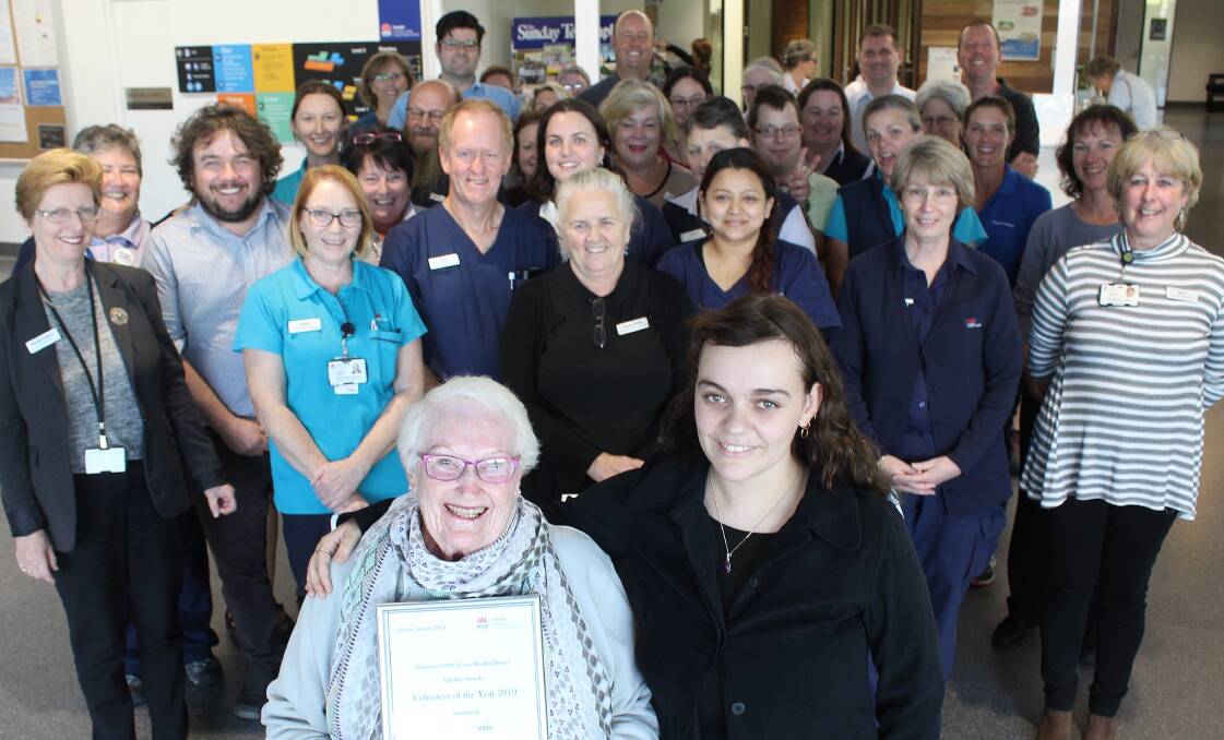 CARER: The 2019 volunteer of the year Quality Award winner Beryl Harris stands with her granddaughter Ella Harris and many supporters at the Bega hospital.
