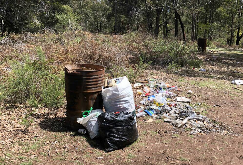 The pictures show the large amount of trash that was left at a site on Fire Shed Trail, near Tathra. 