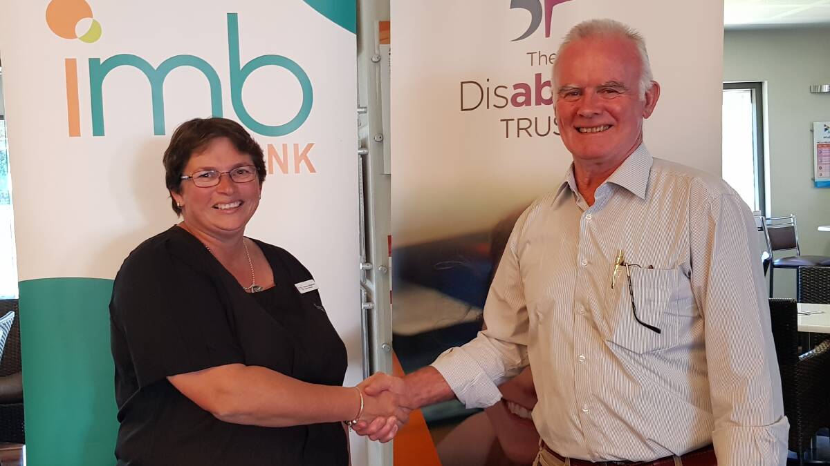 Sharon Shepherd, branch manager IMB Bega, is thanked by WorkAbility's David Grealy for being from one of the three companies sponsoring the prizes for The Disability Trust’s Awards night along with Bendigo Bank and Big W. 