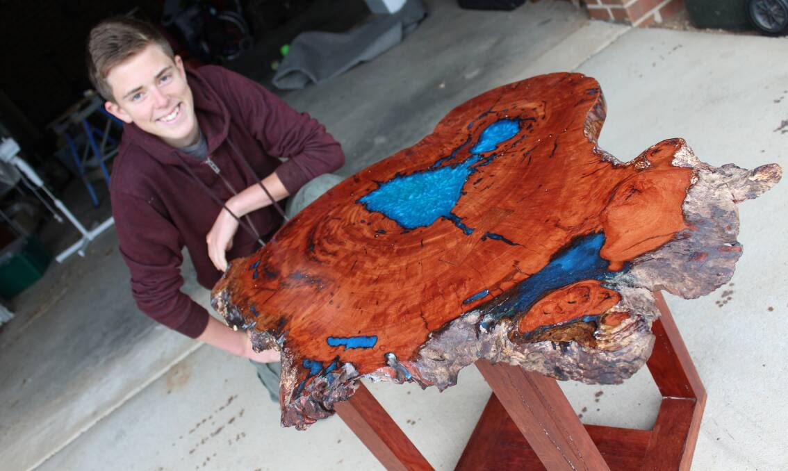 WORKING WITH HIS HANDS: Zac Swan was all smiles after winning the Eden Whale Festival's Artists Who Wood under 18s category with his coffee table. 