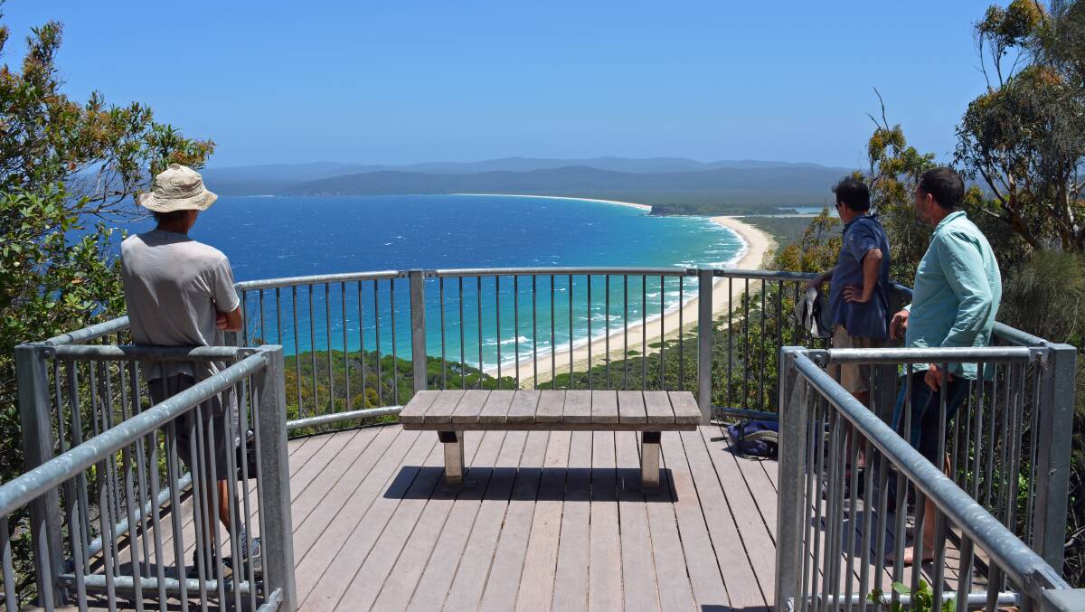 People take in the view at the Disaster Bay lookout. Picture: Ben Smyth
