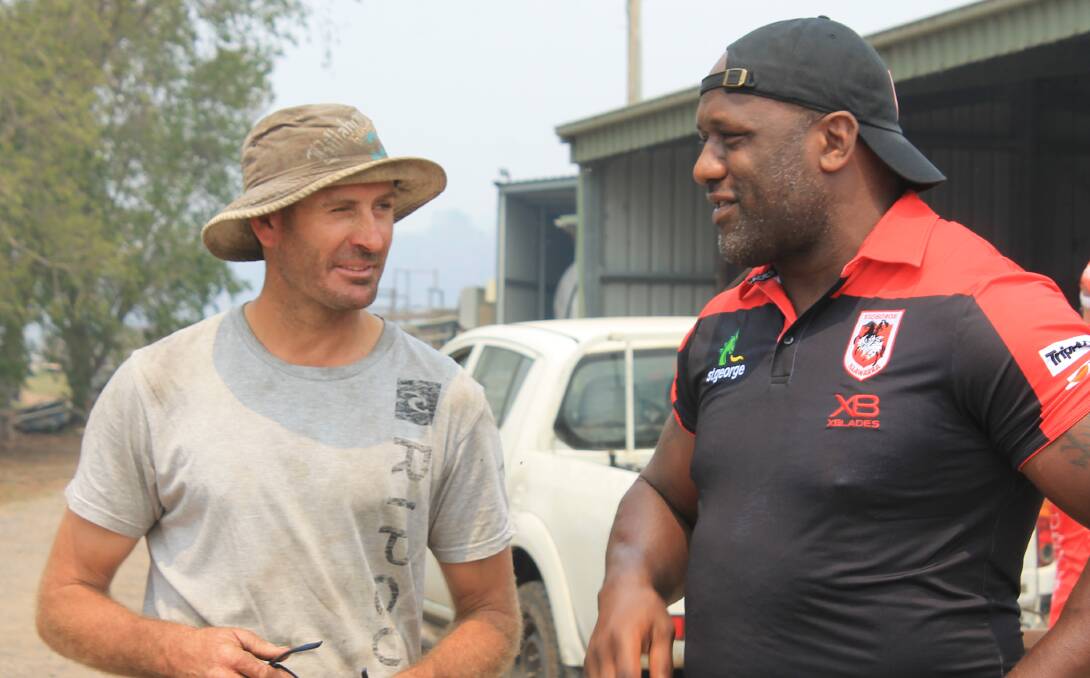 Brett Jessop chats to Wendell Sailor when the St George Illawarra Dragons visit his farm on Wednesday. 