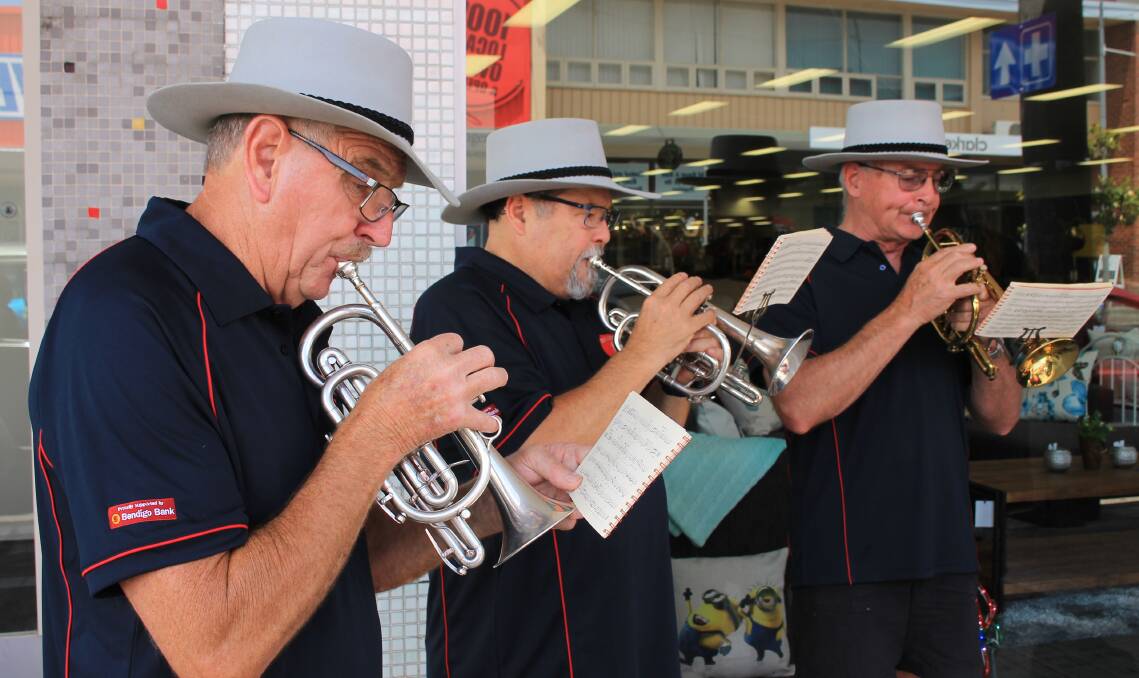 The Bega District Band musicians perform Christmas carols and songs along Carp St in Bega in 2016. 