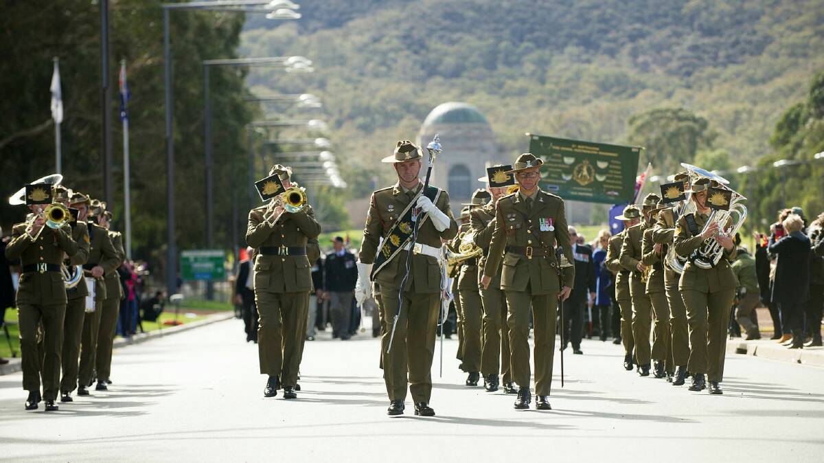 GENEROUS MUSICIANS: The Band of the Royal Military College marches along Anzac Parade in Canberra. 