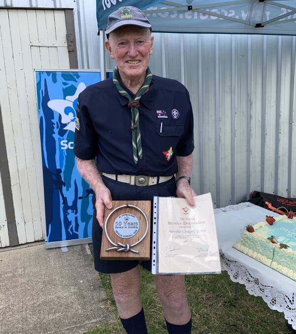 ACHIEVEMENT OF A LIFETIME: Nev Cowgill holds the certificate and plaque presented to him at Cobargo on Saturday for spending 50 years in the Scouts. 