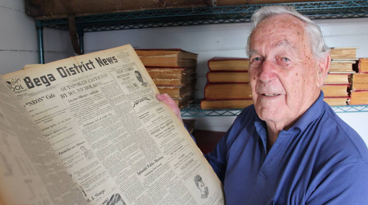 HISTORIC: Peter Rogers examines a bound edition of the Bega District News from 1947 in the Bega museum, which will now house the collection. 