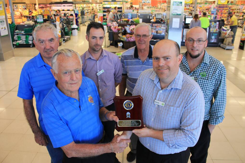 THANKS: Bryson Banfield, Peter Wiley and (third right) Alex Langworthy of Bega Lions present the plaque to Woolworths' Michael Coulter, Hamish Payne and Craig Ferris. 