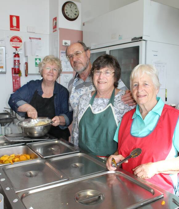 HARD AT WORK: Ricky's Place volunteers Pam Taylor, John and Helen Wyatt and Edna Brown cook up a storm on Friday morning. 