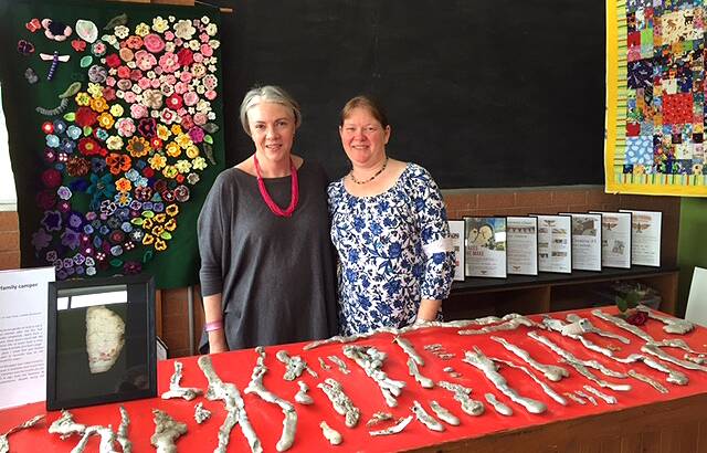 RESULT OF GRANT: Amanda Galvin Myers and Katie Plumb view artworks in the Tathra Firebirds Exhibition, held in November 2018, which was funded from round one of the Recovery and Resilience Grants Program.
