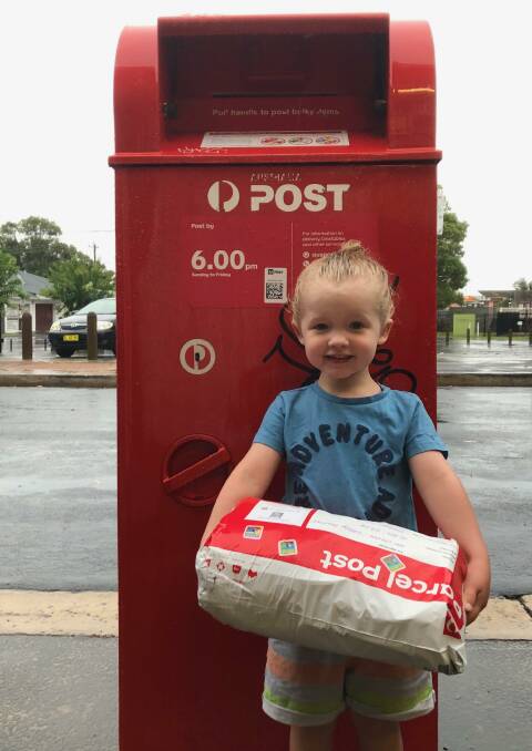 COMPASSIONATE CHILD: Three-year-old Van Clark gets ready to post his parcel of donations from Woonona, near Wollongong, to bushfire-struck Cobargo. 