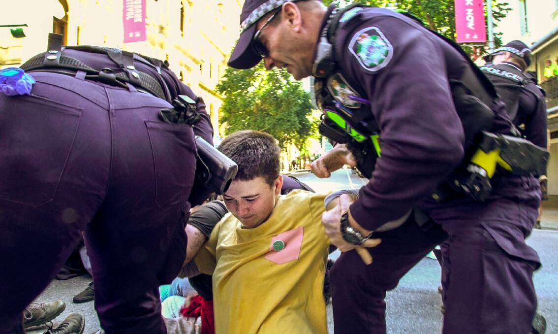 DIRECT ACTION: Doctor George Mountain resident Hannah Doole is arrested by police officers during a climate change protest in Brisbane on Tuesday. Picture: Supplied 