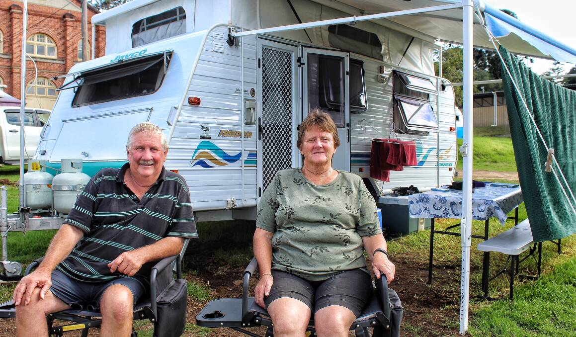 HAPPIER TIMES: Gordon Muir and Denise Pleydell of Tambo Upper relax at Bega Showground on Thursday, March 21, outside the same caravan they stayed in 12 months ago during the bushfire. 