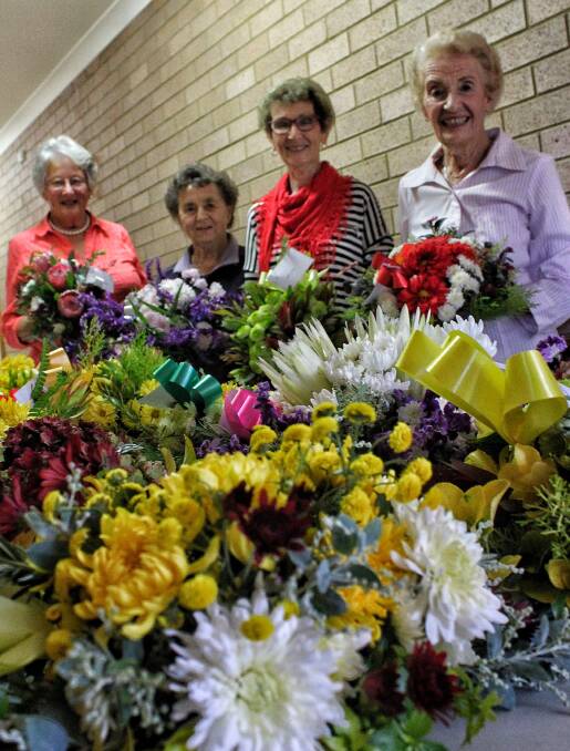 COLOURFUL CREATIONS: Members of the Hillgrove House Auxiliary Helen Slater, Betty Corby, Betty Rood and Pat Durrant make wreaths for Anzac Day. 